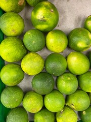 A natural blend of fresh limes with subtle imperfections, showcasing the beauty of real harvest and raw citrus goodness.