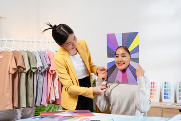Young Asian woman doing personal color diagnosis by Face frames Color Season Kit for determining...