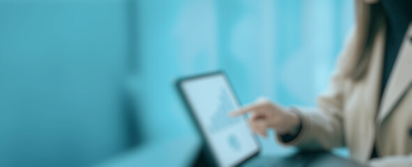 Finger points at data charts displayed on a laptop screen in a bright office environment, illustrating business analysis, digital strategy, and modern decision-making in a professional setting.