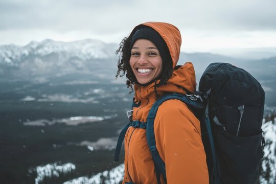 Woman with a bright smile, hiking in snowy mountains. - Powered by Adobe