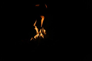 Fire flames on black background. Closeup of fire flames isolated on black background