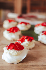 egg white meringue Pavlova desert with mascarpone cheese cream and strawberries