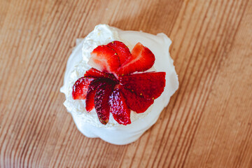 egg white meringue Pavlova desert with mascarpone cheese cream and strawberries
