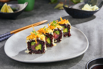 Black rice tuna avocado sushi roll, bright mood, angled plate composition