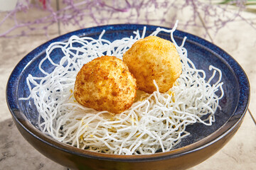 Fried ice cream dessert, bright lighting, overhead view in a deep blue ceramic bowl
