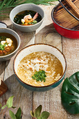 Kani zosui crab soup, bright natural light, rustic overhead presentation