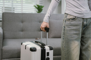 A person is neatly packing clothes into an open suitcase at home, preparing for a vacation or weekend getaway. The scene reflects organization, planning, and excitement.