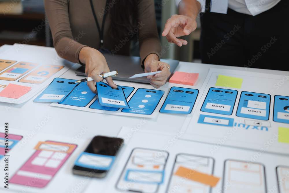 Aufkleber web designers working together on design of mobile app