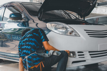 Checking car body work fiber bumper at car garage
