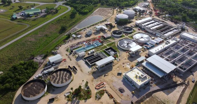 Large-scale industrial water treatment plant purifying and recycling water through filtration and chemical processes to meet health and safety standards.