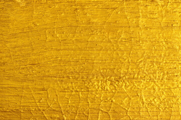 gold paint brushed on concrete wall texture background.