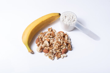 Healthy mix of dried fruits, banana slices, and protein powder, representing a natural,...