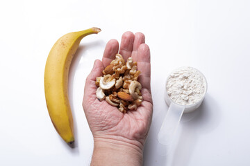 Healthy mix of dried fruits, banana slices, and protein powder, representing a natural, energy-boosting snack ideal for fitness, clean eating, and balanced nutrition.