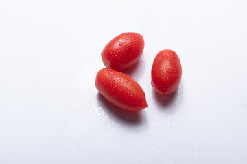 Fresh cherry tomatoes arranged in a natural setting, showcasing vibrant color, juicy texture, and...