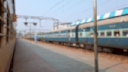 Bokeh view outside of moving suburban passenger train running to Mumbai, Maharashtra, India. Blurred background footage.