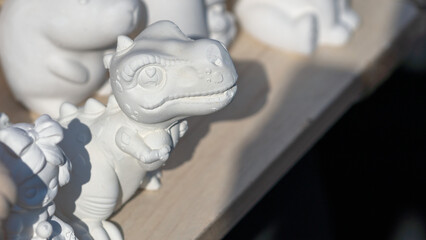 Unpainted white ceramic dinosaur figure ready for hand painting and decoration.
