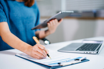 business documents on office table with smart phone and digital tablet and graph financial and...