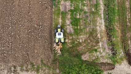 Agricultural Landscape with Tractor and Harvesting in a Rural Setting Top View of Farming Operation...