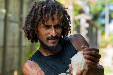 Local man peeling a fresh coconut in Tortuguero, Costa Rica