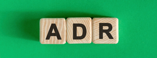 ADR text on a green background on wooden cubes