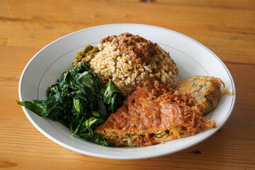 Nasi Padang with Minang-Style Omelette, Indonesia, captured on June 22, 2025. Traditional rice dish served with thick spiced omelette, curry sauce, vegetables, and sambal for a rich and hearty flavor.