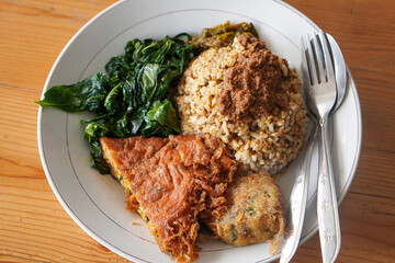 Nasi Padang with Minang-Style Omelette, Indonesia, captured on June 22, 2025. Traditional rice dish served with thick spiced omelette, curry sauce, vegetables, and sambal for a rich and hearty flavor.
