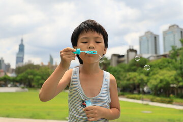 Boy blowing bubbles.