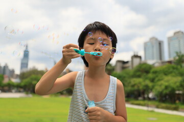 Boy blowing bubbles.