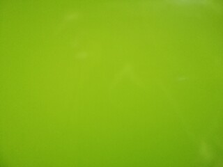 A solid, flat surface of a vibrant, bright lime-green color background. Ideal for graphic design