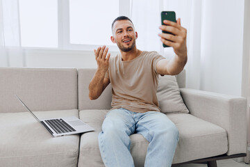 Man engaging in a heartfelt video call, showcasing emotional vulnerability and connection in a cozy...