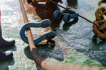The towing equipment on main deck of the offshore support vessel. The crew is setting up a GOG wire...