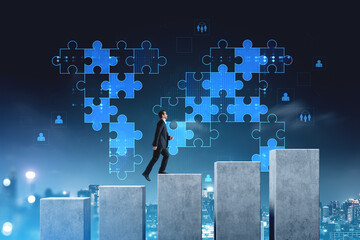 Businessman climbing concrete steps with digital blue puzzle pie