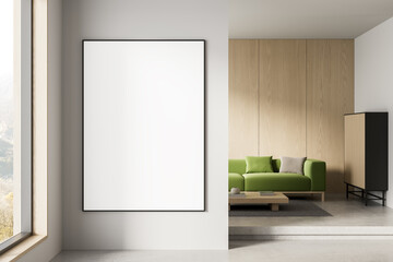 Blank poster mockup in modern interior with wooden panel wall and green sofa in clean minimalist living room layout for branding or design display. 3D Rendering