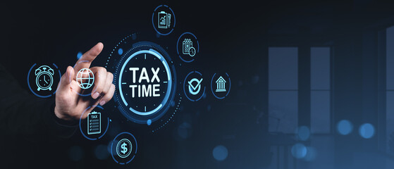 Hand pointing at tax time icon surrounded by digital financial symbols on dark modern office background with blue futuristic interface concept..