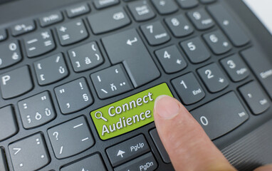 Connect your audience key on a gray keyboard. Finger pressing key