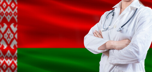 Doctor with crossed arms on Belarus flag. Belarus health and care concept. Female doctor on Belarus...