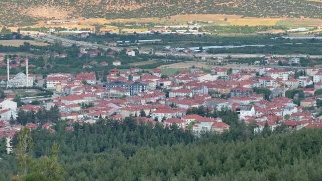 View from the mountain to the town of Korkuteli, Antalya. Panoramic view of the city. Houses with rooftops. Daytime