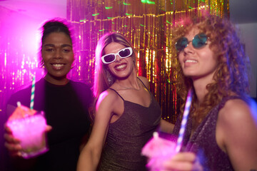 Friends enjoying cocktails at trendy nightclub party