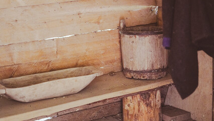Rustic wooden bath accessories including old bucket and small tub indoors
