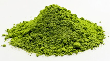 A vibrant green pile of finely ground powder sits on a clean white surface