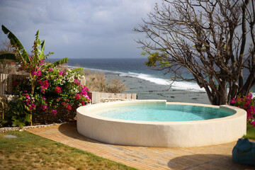 White Circular Pool with Ocean View in Tropical Setting