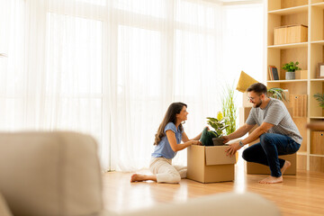 Excitement fills the air as a couple unpacks treasured belongings in their new home together