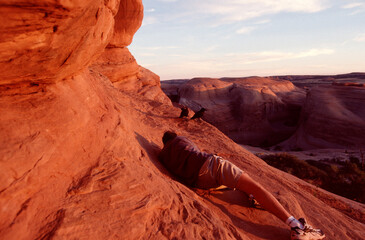 Photographer taking pictures of Arches National Park and crows at sunset