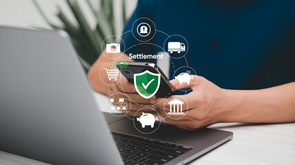 A digital Settlement transaction illustration showing hands holding a smartphone over a laptop keyboard.