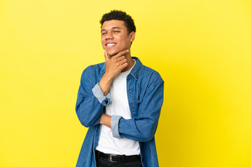 Young African American man isolated on yellow background happy and smiling