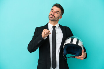 Business caucasian man with motorbike helmet isolated on blue background proud and self-satisfied