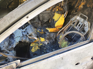 Inside view of a destroyed from fire car.  Close up view.

