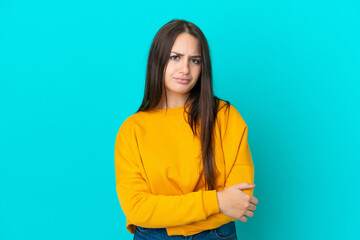 Obraz premium Young Ukrainian woman isolated on blue background feeling upset