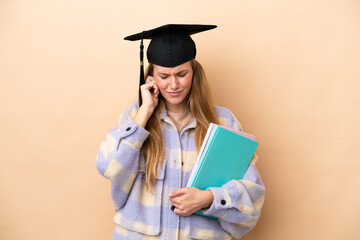 Young student woman over isolated background frustrated and covering ears