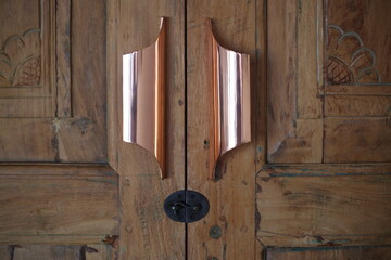 Antique Carved Wooden Doors with Brass Handles and Latch